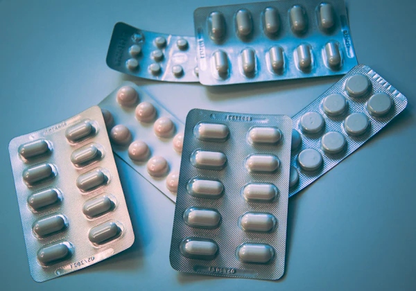 Prescription medication bottles and pills on a pharmacy shelf