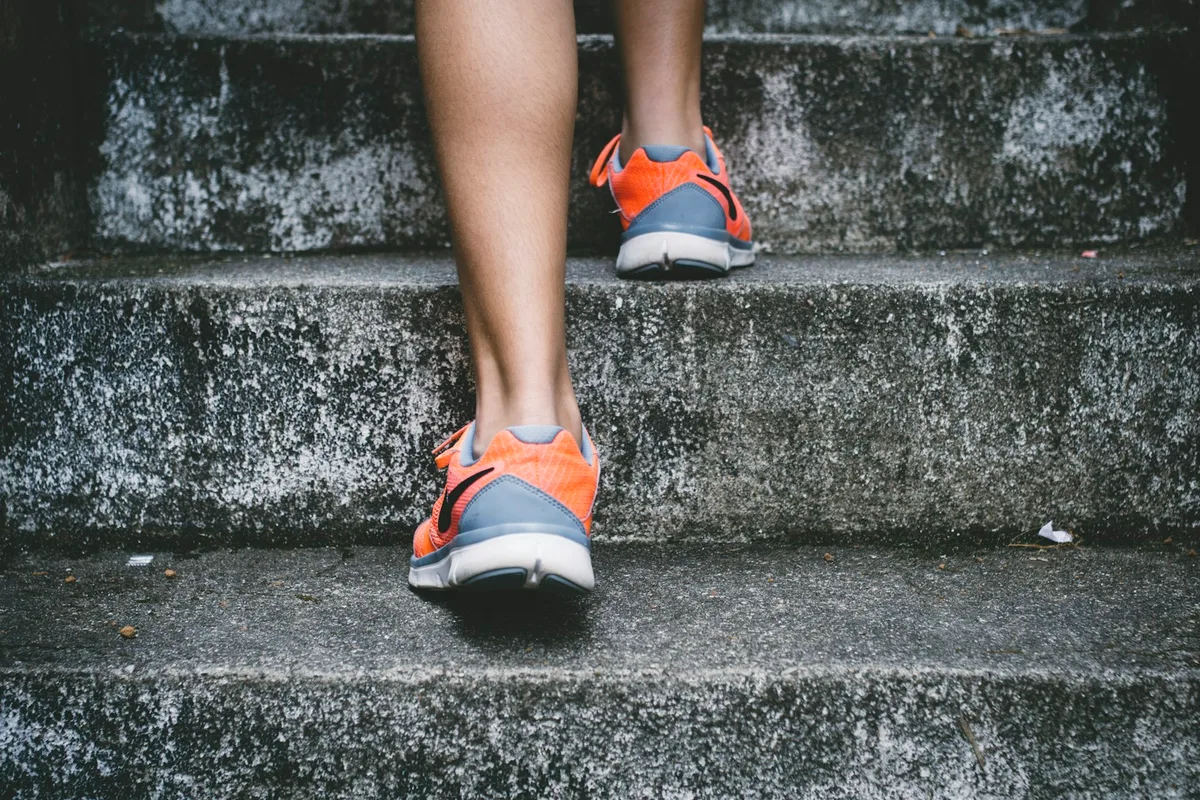 Adult running outdoors as part of a wellness and fitness routine